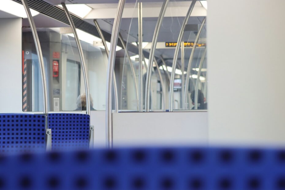 a train station with a person walking on the platform